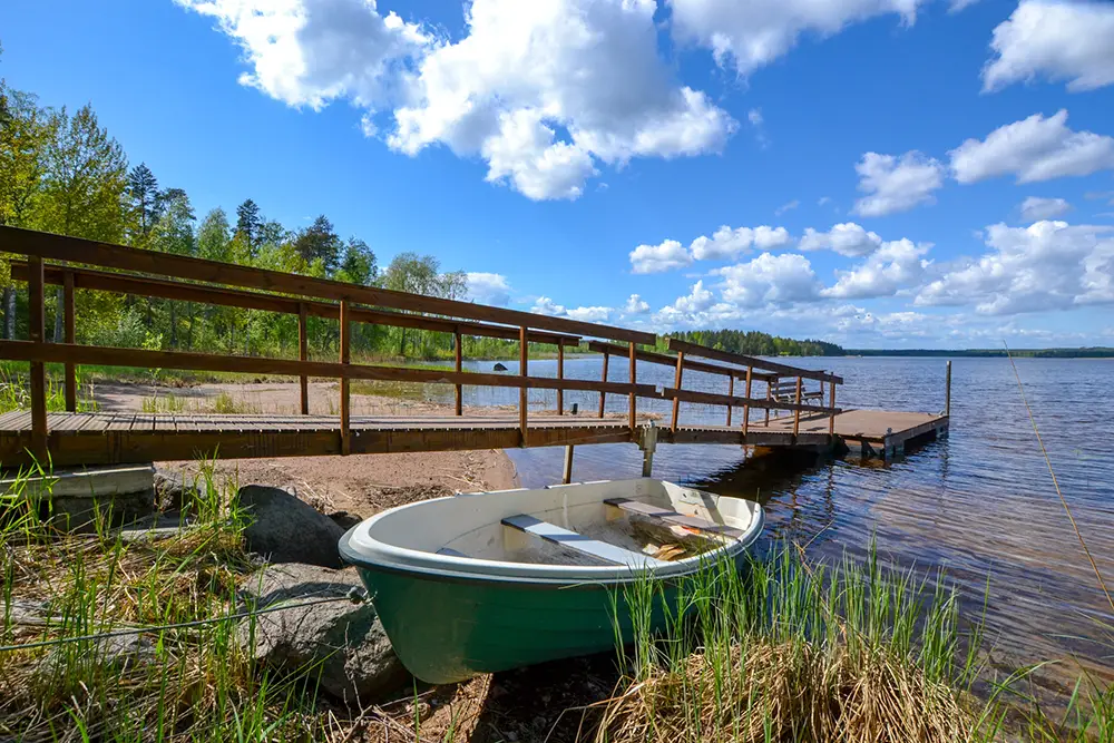 Pier and rowing boat at Saimaa Lakeside cottage