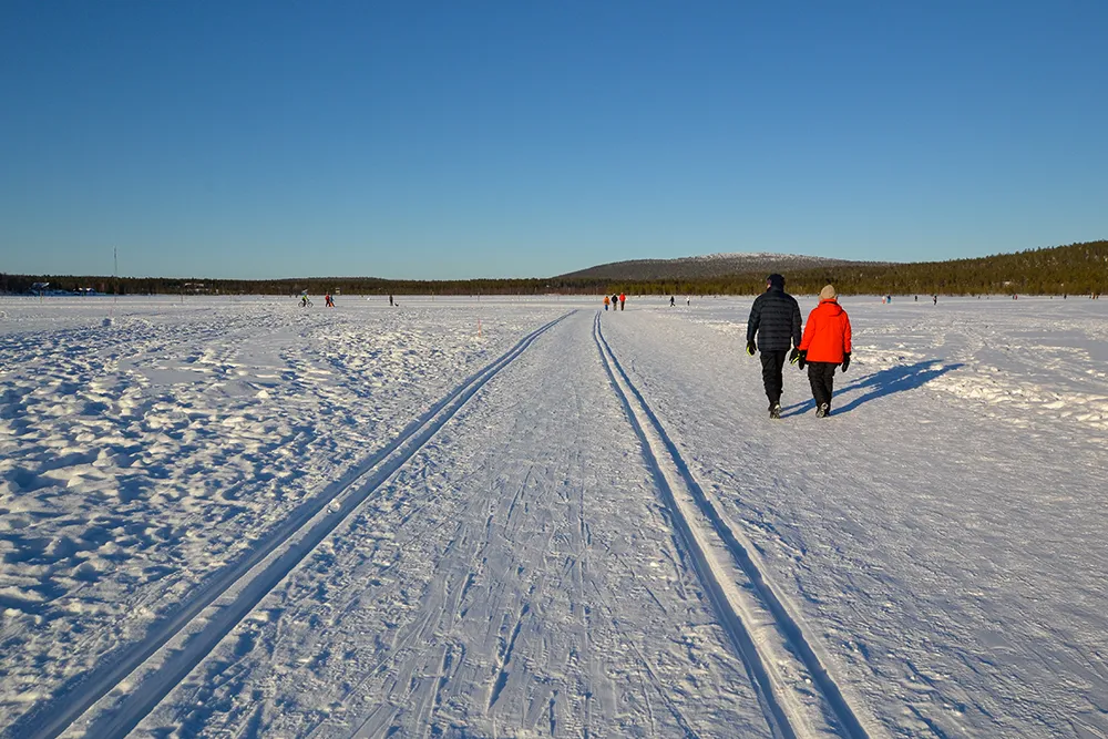 People walking on frozen lake in Ylläs, Lapland
