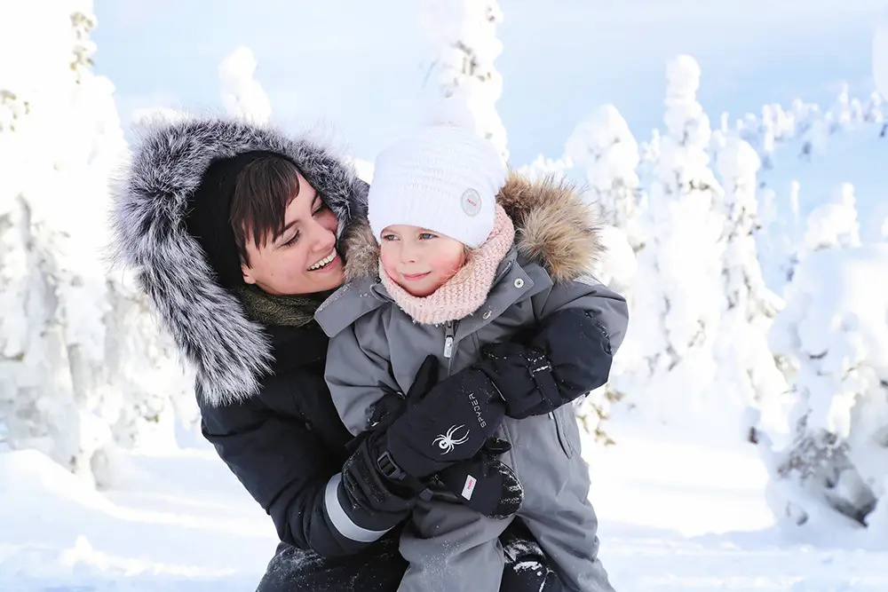 Woman with child in Ruka, Northern Finland - Photo: Harri Tarvainen / Visit Finland